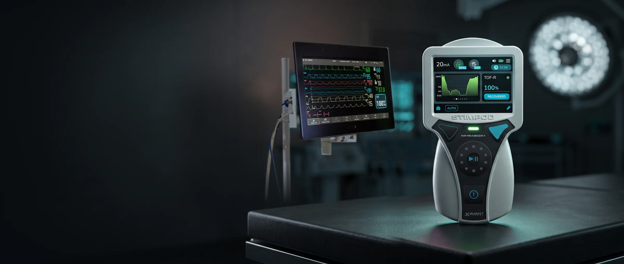 A Stimpod™ NMS450X+ on an operating table, with a patient monitor out of focus behind it showing heart rate, saturation and the NMT values TOF ratio 100% and TOF count 4